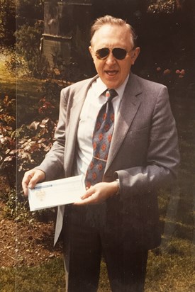 Dad receiving cheque from sale of Woodbridge shares 