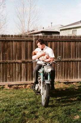 Ron on his motorcycle with baby Daniel