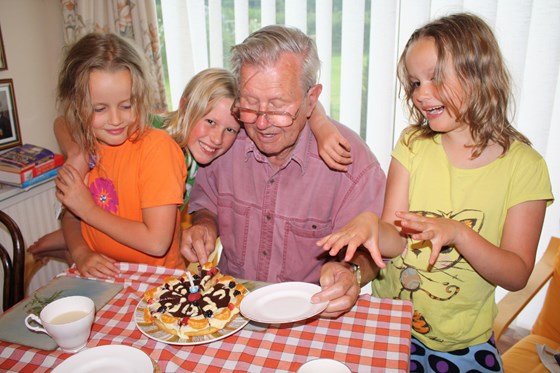 Geoff with his birthday cake and 3 grandchildren in 2009