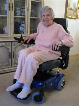 Mom in new power chair in Courtyards apartment