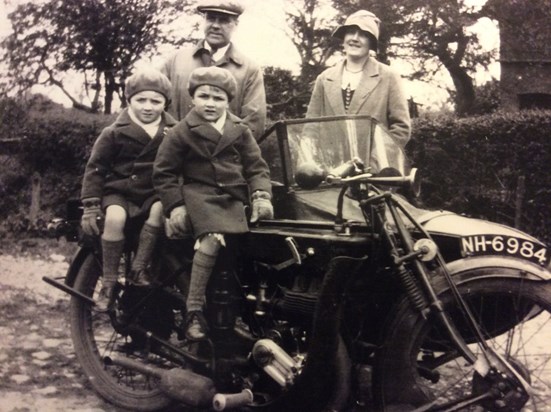 Roy (left) and his brother on the bike, with their parents