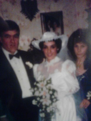 Carol with her parents on her wedding day