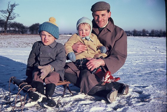 Mike with dad Geoff and brother Ian.  He started the tobogganing and snow fascination early!