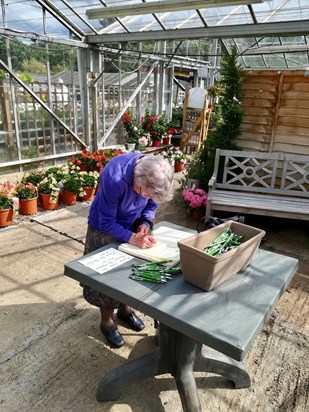 Sheila Meeks 90th birthday at Finchley Nurseries. -  signing the visitors book! 