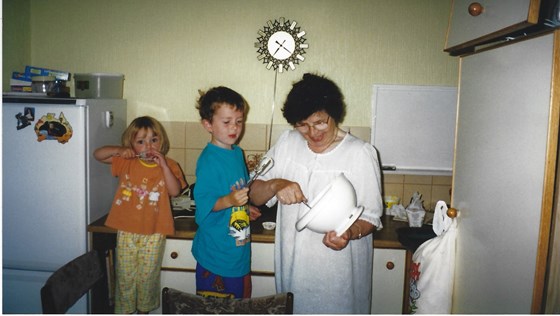 Tess and her grandchildren Liam and Niamh baking.