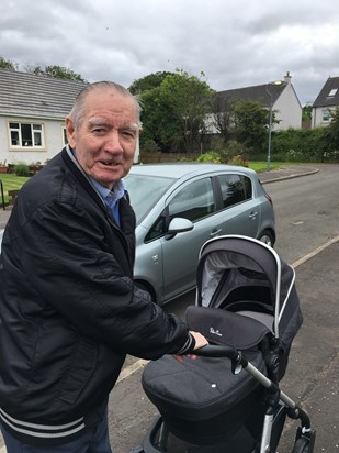 Great granda Willie pushing the pram for the first time