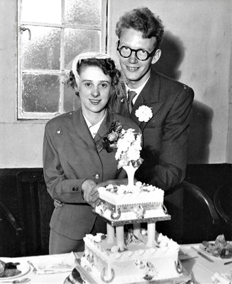 Mum and Dad cut the cake on their wedding day.