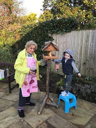 Grandma (doreen) with Riley (great grandson) filling the bird feeders