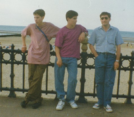 Dad with sons thinking their gangsters at the beach in early 1990s