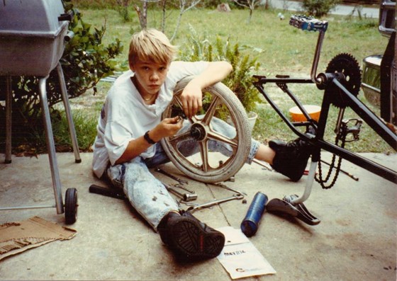 Troy as a young boy, working on his bike