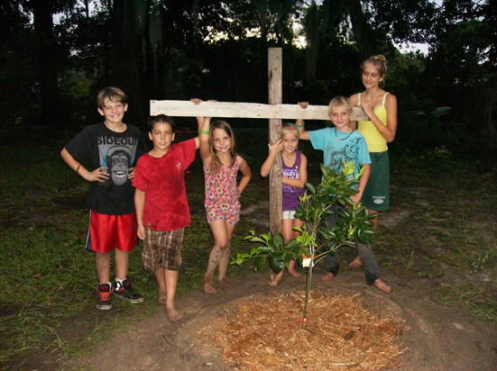 We planted your Memorial Orange Tree today, the kids made the cross for you.