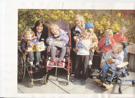 Mum sharing out easter eggs at a special needs school