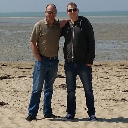 On the beach in France with his dad