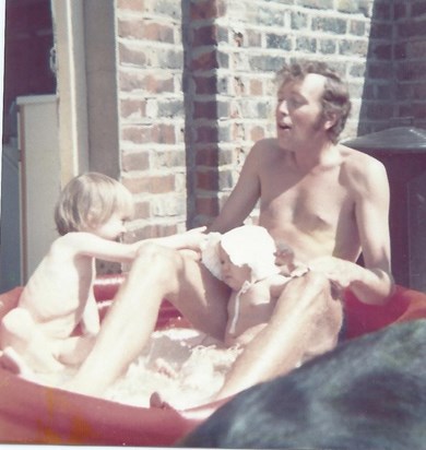 In a paddling pool on Gill's balcony with Simon and Emma (and a friend's dog in front). May1974