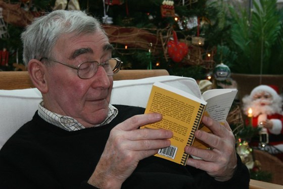 Colin engrossed in a book, one of his favourite pastimes.