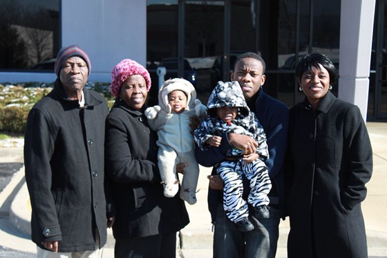 Grandpa posing with family during Opeyemi's relocation to chilly St. Louis, MO