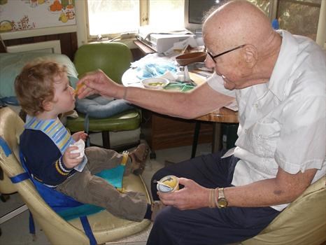 Grandpa Harvey feeding Nathan yogurt, Nov 08