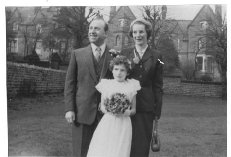 Sue as a bridesmaid with her mum and dad