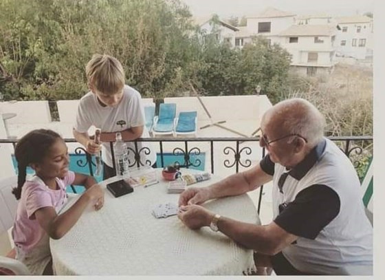 Paps teaching his Grandchildren to play cards