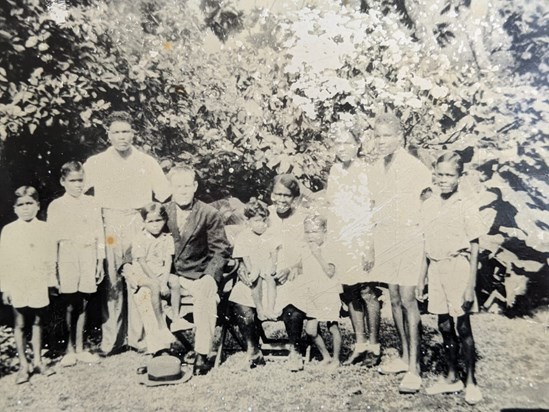 Dad sitting in Grandpa Norbert knee with all his family in Dominica