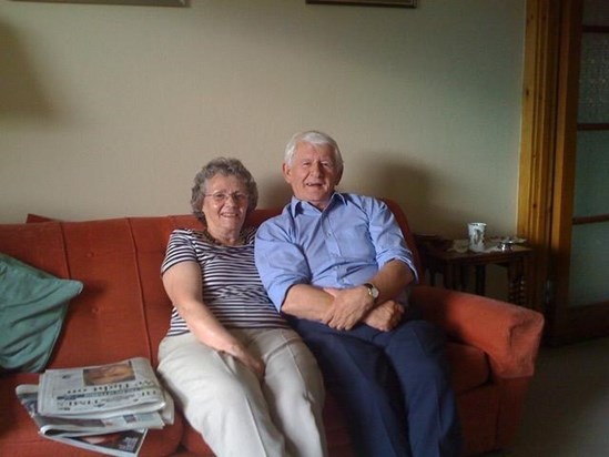 Trev and Di at home on their couch (that lasted all their married life!)