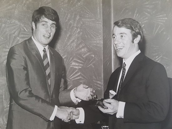 Receiving one of his many football trophies from Bobby Ferguson. West Ham's goalkeeper in the 60s