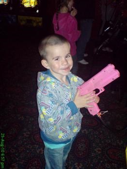 Tyler and his PINK gun :-) on holiday aged 4.
