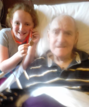 Erin showing Grandpa her sports medal (120616)