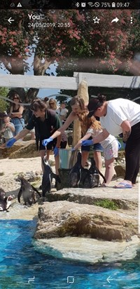 Feeding penguins for her 30th