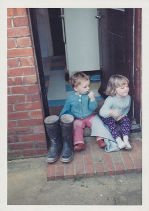 By the back door, next to Dad's wellington boots