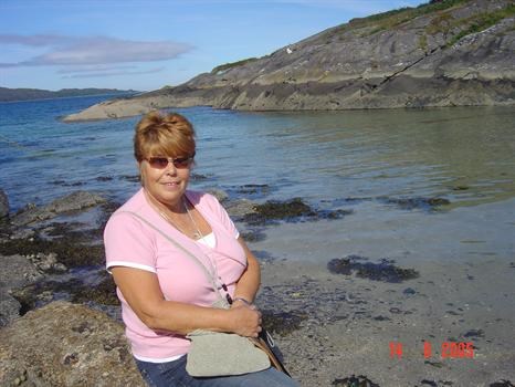 Mum sitting on a rock, overlooking a loch in Scotland xxx