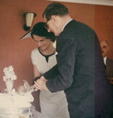 Eileen and St John cutting their wedding cake