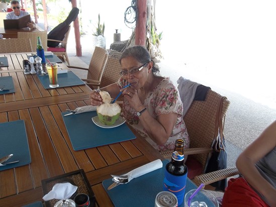 Mumtaz enjoying a fresh coconut.