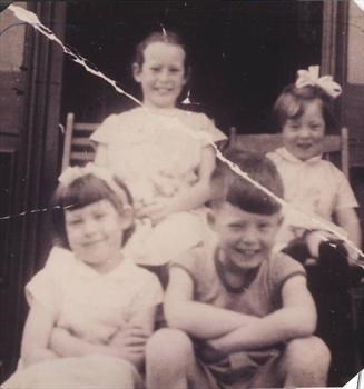 Pete with 3 of his sisters on the steps of Miss Costains - the family holiday 1959