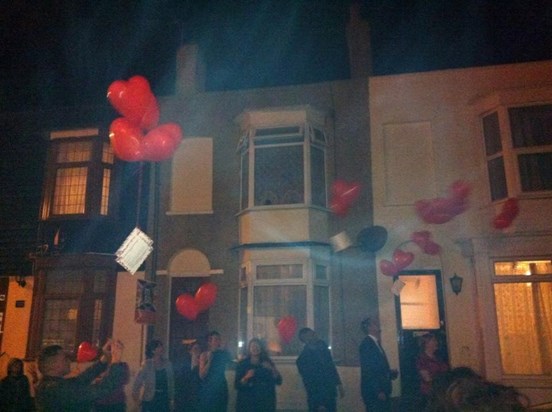 Friends and family release ballons with a message the day of mums funeral