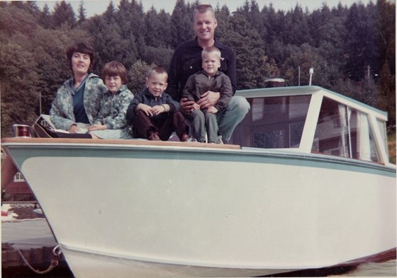 Larry and Barb with their kids Rina, John, and Dale on a boat