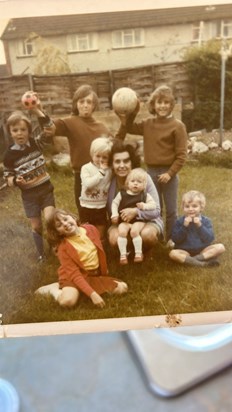 Beloved nan with all her grandchildren steve and mark behind her with ball