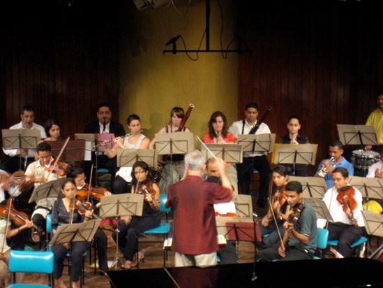 Mumbai - Conducting the orchestra in the memorial concert for those that died in the Mumbai Bombings.