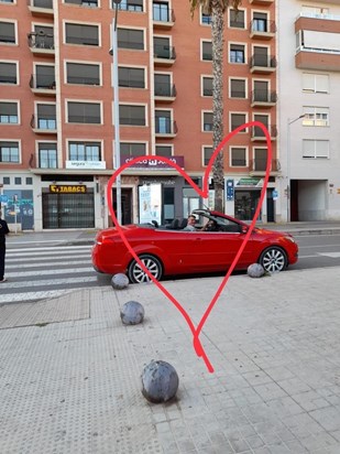 Karl in his little red convertible in Spain