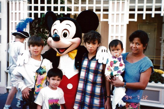 Auntie Baby holding Rachel, with Richard, Donna, Aaron, and Mickey Mouse at Disneyland, 1994