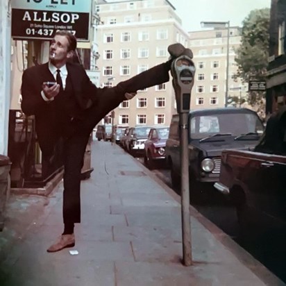Mick Supporting A Parking Meter......