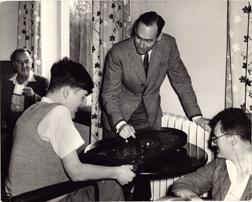 Leonard Cheshire, Jim Besta and other unidentified residents playing games in the bar at Le Court.