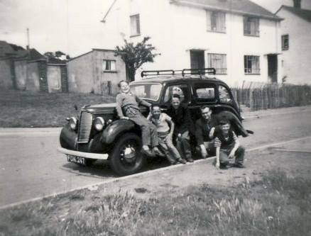 Dad on the car 1960 with his brothers.  Kent, a family outing.  Obviously having fun :)