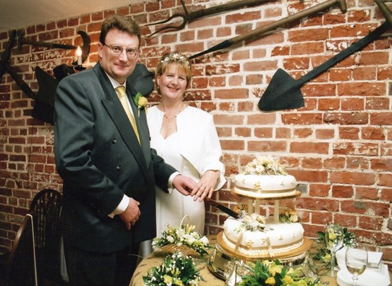 Wedding day reception at Frogpool Manor Restaurant: Patricia and Kevin cut the cake