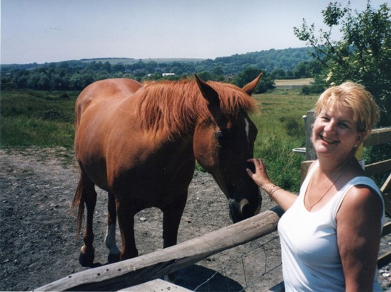 Horsing around: Patricia strokes a horse in the Cuckmere Valley in Sussex