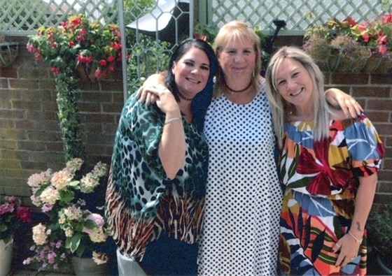 Flower power: Patricia flanked by daughter Claire (left) and next door neighbour Lynne in the back garden