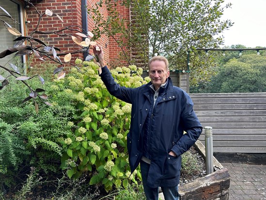 Kevin lovingly touches Pat's personalised leaf on the hospice's Memory Tree