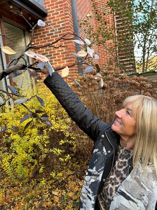 Take two: Lynne Smith admires Pat's second leaf to adorn the hospice's Memory Tree