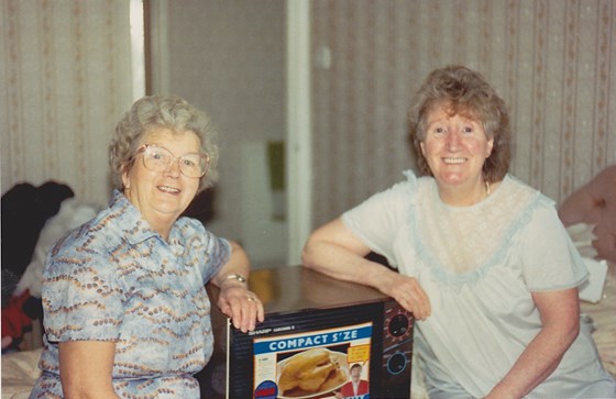 Mom and Elsie on her 60th with microwave - just before she went to get her bus pass!