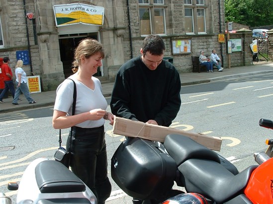 Paul and Coral trying to figure out how to get whatever this is home on a motorbike. Lakes June 2003